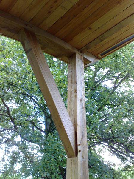 External oak frame under a balcony.