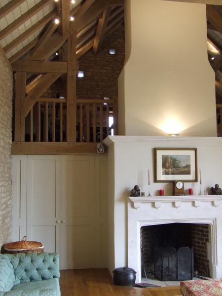 Chimney breast in the double height living room of an oak barn.