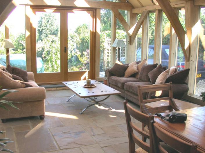 A sunny lounge in a green oak extension.