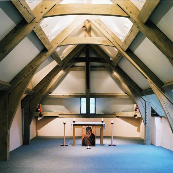 A chapel in the roof space of an oak framed cob barn.
